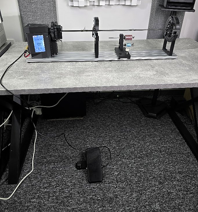 FRW4 on a desk with two rod supports and a rod, the foot pedal on the floor below